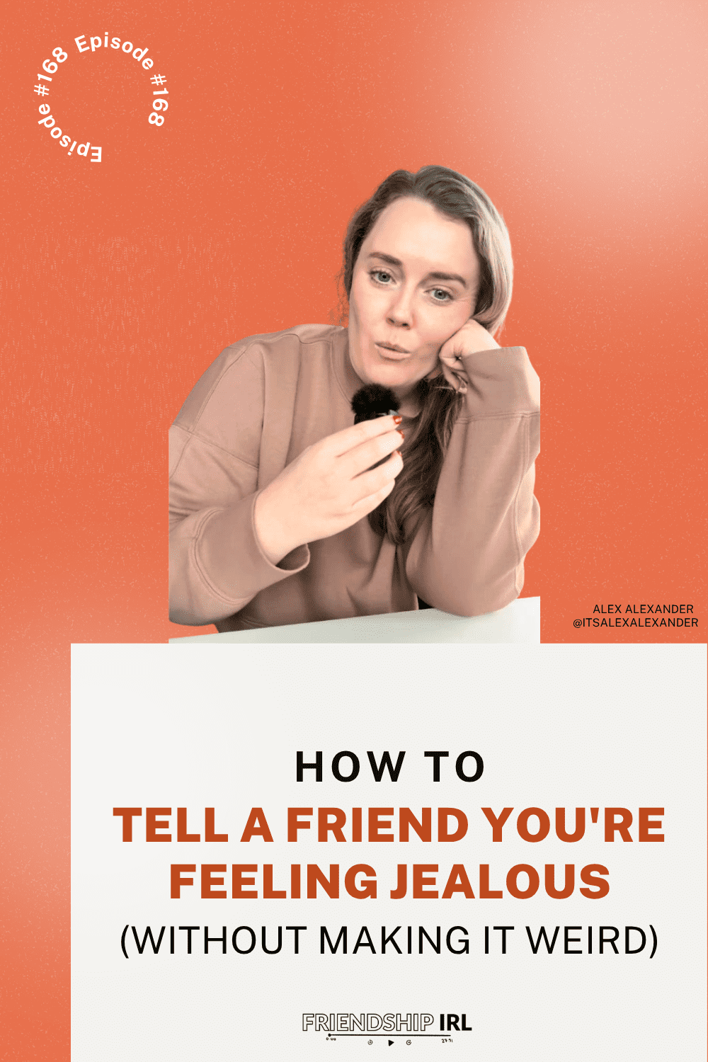 Friendship IRL podcast promotional graphic for Episode #168. The image features an orange-red gradient background with a woman in a beige/tan hoodie sitting at a white table, holding a makeup brush to her face while resting her chin on her other hand. Large bold text reads "HOW TO TELL A FRIEND YOU'RE FEELING JEALOUS (WITHOUT MAKING IT WEIRD)" with the episode number "#168" curved in the top left corner. The bottom right shows "ALEX ALEXANDER @ITSALEXALEXANDER" and the Friendship IRL logo appears at the bottom.